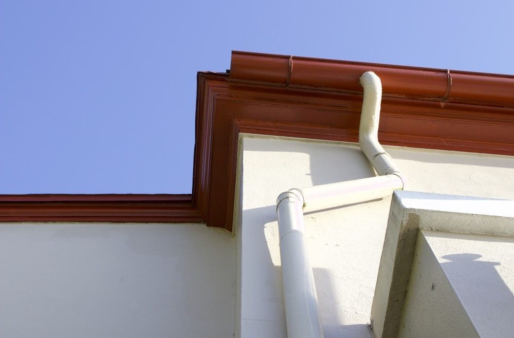  A pipe leading from the gutter of a house