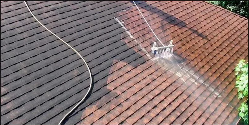 roof getting cleaned with a pressurized water machine